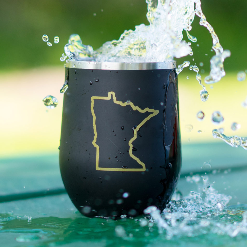 Black tumblr with shape of Minnesota with water splashing into it