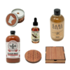 Cocktail syrup, Bloody Mary mix, wood candle, bitters, and wood coasters on white background.