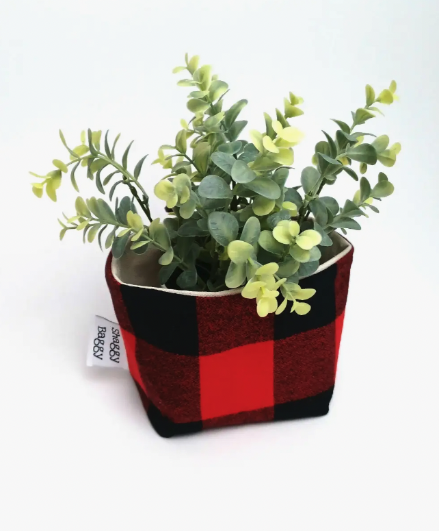 shaggy baggy small red and black cloth container with plastic plant inside